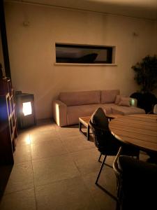 a living room with a couch and a table at Suite Romantique Reve d Amazonie option espace Spa complet en supplément in Les Mages +29 photos