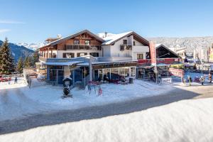 a building in the snow in front of a ski resort at HOLIDAY Apartments in Jerzens