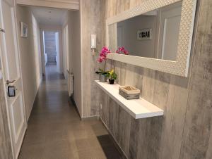 a hallway with a sink and a mirror on a wall at Apartamento Martin in Tossa de Mar +20 photos