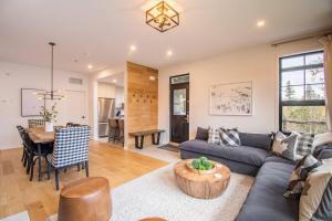 a living room with a couch and a table at Unwind in Style Les Eaux 215-6 in Mont-Tremblant