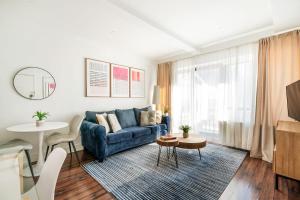 a living room with a blue couch and a table at 809-4A Columbus Circle New BLDG 1BR W D in New York