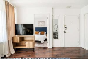 a bedroom with a bed and a television on a table at 809-4A Columbus Circle New BLDG 1BR W D in New York