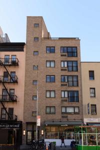 a tall brick building with a person walking in front of it at 809-4A Columbus Circle New BLDG 1BR W D in New York