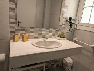 a bathroom with a sink and a mirror at Apartamento Martin in Tossa de Mar