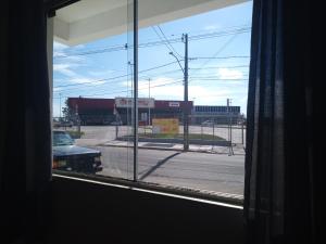 a window view of a parking lot with a truck at Pousada in São Gabriel