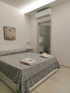 Ένα ή περισσότερα κρεβάτια σε δωμάτιο στο Ninfa Bed and Breakfast