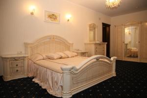 a hotel room with a bed and a dresser at Kleopatra VIP hotel in Kamianets-Podilskyi