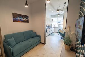 a living room with a couch and a kitchen at Cerasè Apartment in center-Sorrento Coast in Vico Equense