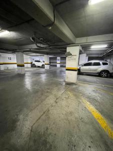 a parking garage with two cars parked in it at Hotel Portal Central in Medellín