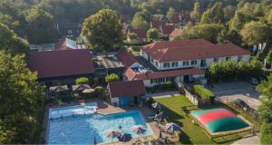 an aerial view of a house with a swimming pool at Forest View Lodge Diessen in Diessen