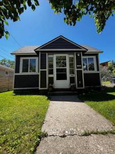 a home with a black and white screened in porch at The Purple Palace - Historic Downtown BZN in Bozeman