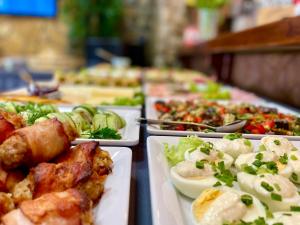 a buffet with plates of food on a table at Sztygarka Hetmańska Resort Solina in Solina +183 photos