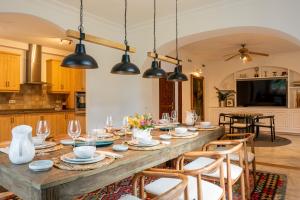 a kitchen and dining room with a wooden table and chairs at La Pinta Golf Villa Sotogrande in Sotogrande