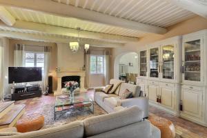 サン・カナにあるCharming Provence Retreat with Heated Pool and Jacuzziのソファとテレビのあるリビングルーム