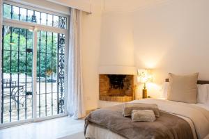 a bedroom with a large bed and a fireplace at La Pinta Golf Villa Sotogrande in Sotogrande +58 photos
