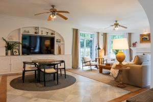 a living room with a couch and a table at La Pinta Golf Villa Sotogrande in Sotogrande