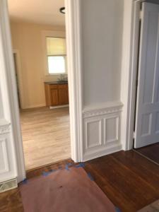 an empty room with a white door and wooden floors at Home Support And Care LLC in Binghamton