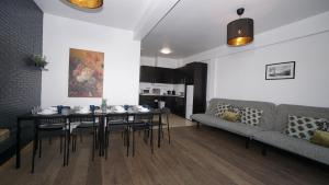 a living room with a table and a couch at Brial apartment 2 bedrooms, in Antwerp