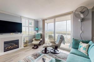 a living room with a fireplace and a tv at Bonita Beach- Seas The Day! in Bonita Springs