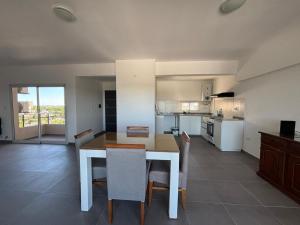 a kitchen and dining room with a table and chairs at Harmony Center Junin in Junín