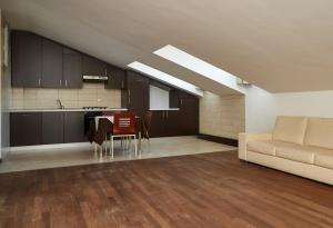 a kitchen and living room with a couch and a table at Green Garden APARTMENTS in Chirignago