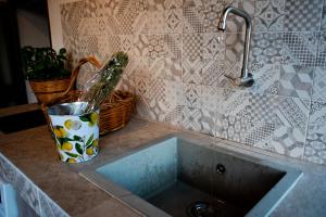 a kitchen counter with a sink and a faucet at La Cortese, cuore barocco in Noto +46 photos