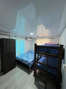 a bedroom with a bed and a bunk bed at San Angel in La Loma