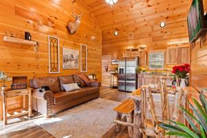 a living room with a couch and a kitchen at Heavenly Bliss By Ghosal Luxury Lodging in Sevierville