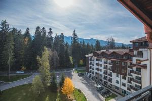 a view from a balcony of a building and a street at Borovets Gardens Aparthotel Seasons Borovets PM in Borovets