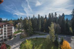 an aerial view of a park in front of a building at Borovets Gardens Aparthotel Seasons Borovets PM in Borovets