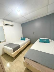 Postel nebo postele na pokoji v ubytování Hotel Puerto Vigia Inn