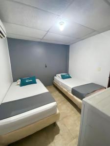 Postel nebo postele na pokoji v ubytování Hotel Puerto Vigia Inn
