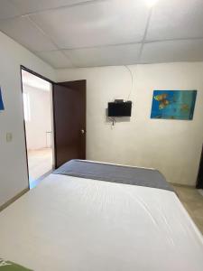 Postel nebo postele na pokoji v ubytování Hotel Puerto Vigia Inn