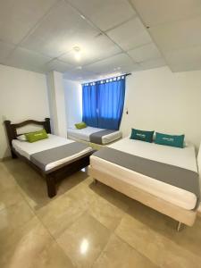 Postel nebo postele na pokoji v ubytování Hotel Puerto Vigia Inn