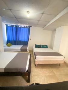 Postel nebo postele na pokoji v ubytování Hotel Puerto Vigia Inn