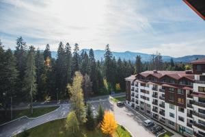 an aerial view of a building with trees and a street at Borovets Gardens Aparthotel Seasons Borovets PM in Borovets