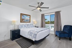 a bedroom with a bed and a blue chair at Live in the Sunshine-DMBC148N in Solana Beach +43 photos