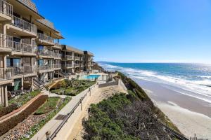 a view of the beach from the balcony of a resort at Live in the Sunshine-DMBC148N in Solana Beach