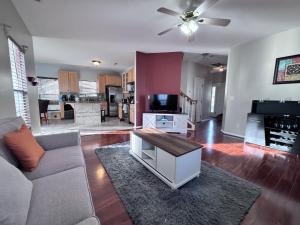 a living room with a couch and a table at Amazing 4 BDRM home w garage in Charlotte in Charlotte