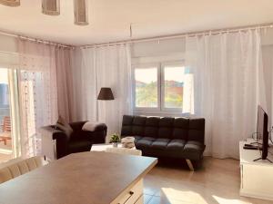 a living room with a couch and a table at Villa Bacchus in Nikiti