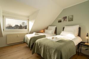 Postel nebo postele na pokoji v ubytování Sali Homes - Turmhaus am Wilhelmsplatz