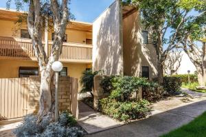 a building with trees and bushes in front of it at Oceanfront Sea'batical - SBTC212 in Solana Beach