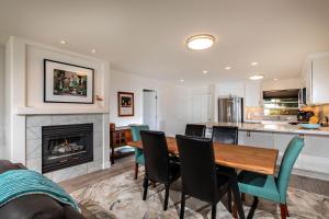 a kitchen and dining room with a table and chairs at Serenity By The Sea - SBTC202 in Solana Beach