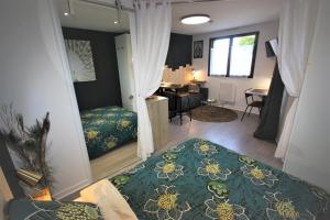 a bedroom with a bed and a desk in it at L'Appart - Résidence Chez Gally à Angers in Les Ponts-de-Cé