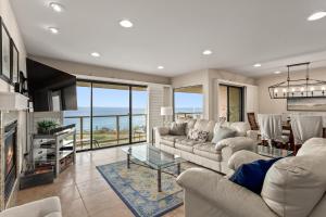 a living room with a couch and a table at Bella Vista - SUR111 in Solana Beach