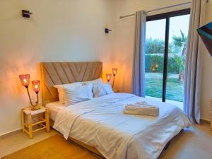a bedroom with a bed and a large window at Villa soléa - Route Ouarzazate in Marrakesh +35 photos