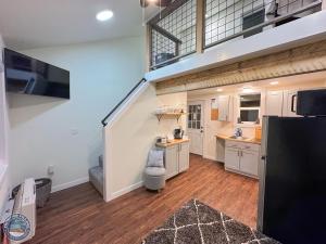a large kitchen with white cabinets and a staircase at The Wandering Wolf - Frontier Village in North Pole