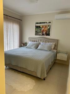 Giường trong phòng chung tại Casa de Praia em PONTA DAS CANAS, FLORIANÓPOLIS