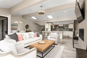 a living room with a white couch and a table at Endless Summer - SUR149 in Solana Beach
