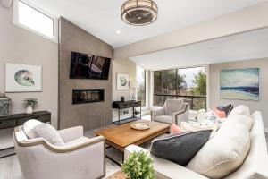 a living room with a couch and chairs and a table at Endless Summer - SUR149 in Solana Beach
